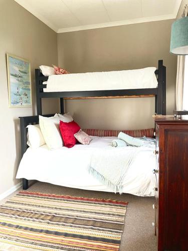 a bedroom with two bunk beds and a rug at Kerriston Guest House in Mooirivier
