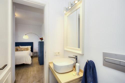 a bathroom with a sink and a bed in a room at Casa La Malondra in Puerto del Carmen