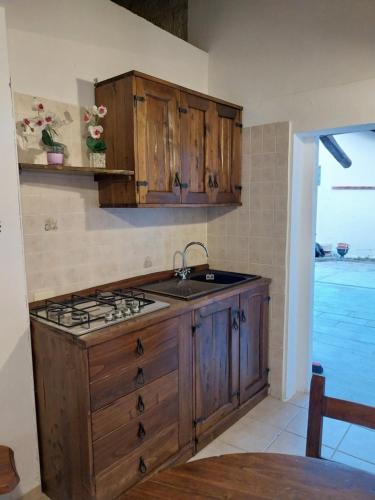 a kitchen with a sink and a stove in it at Casal Baratz in Santa Maria la Palma