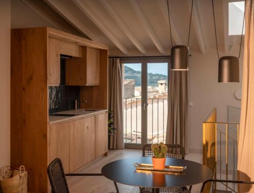 a kitchen and dining room with a table and a view at Can Verí Suites in Sóller