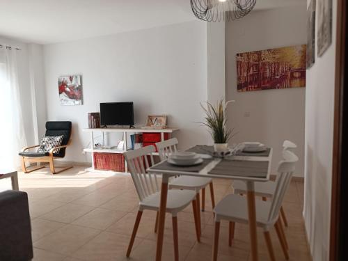 a living room with a dining room table and chairs at Centro Histórico de Málaga in Málaga