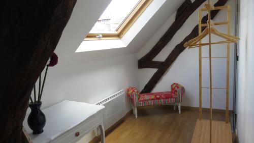 a room with a staircase with a chair and a window at Chez Mary Poppins in Vernon