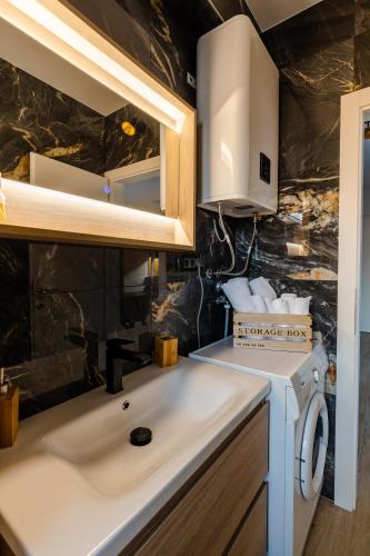 a kitchen with a sink and a washing machine at Apartment Dado in Trogir
