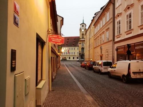 a street with cars parked on the side of the road at Apartman Deluxe Cheb in Cheb