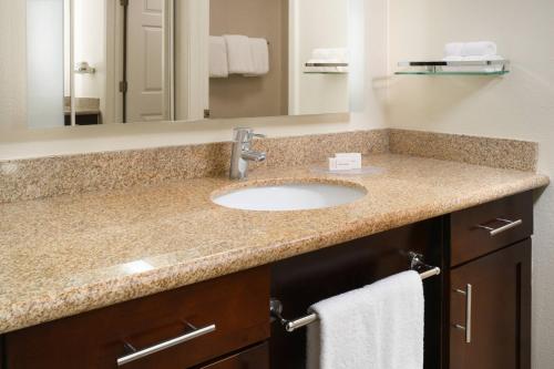 a bathroom with a sink and a mirror at Residence Inn Houston Westchase On Westheimer in Houston