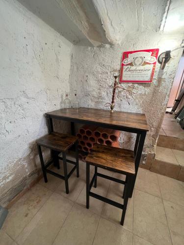 a wooden table and a stool in a room at Casa rural El encanto in Zarra