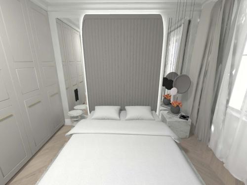 ソポトにあるApartament Lux Sopot Monte Cassinoの白いベッドルーム(大きな白いベッド1台、鏡付)