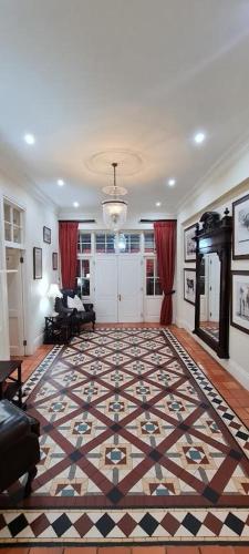 a living room with a large rug on the floor at Kerriston Manor House in Mooirivier