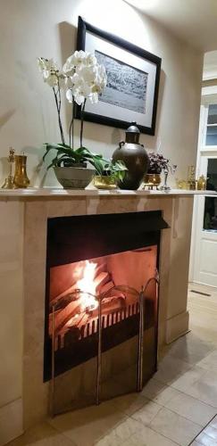 a fireplace in a living room with a fire place at Kerriston Manor House in Mooirivier