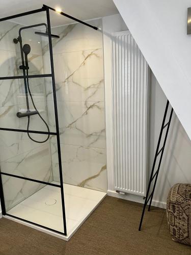 a glass shower in a room with marble walls at Chalet 190 La Belle Durbuy in Durbuy