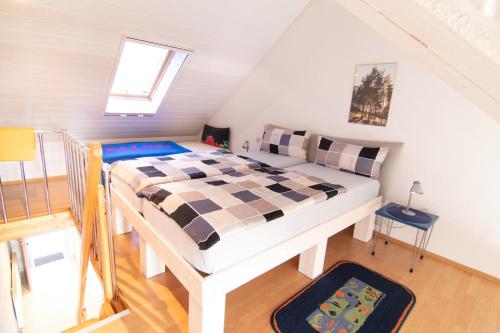 a bedroom with a bed in a attic at hausANNA - casaNAUTICO in Ueckermünde