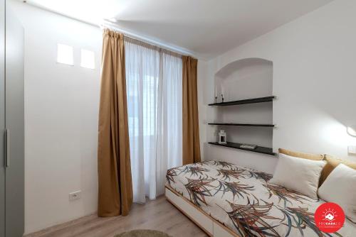 a bedroom with a bed and a window at Wild Zagara Garden View in La Spezia
