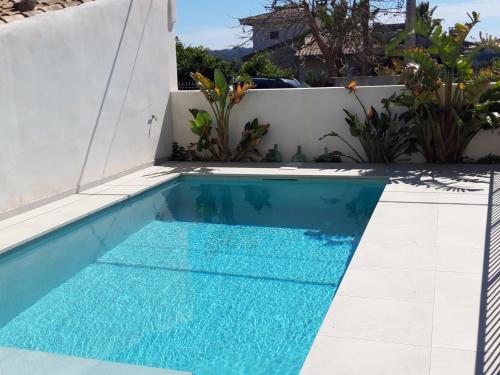 a swimming pool in the backyard of a house at CASA PISCINA DOCTOR FLEMING 51 in Llubí