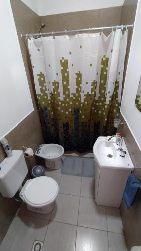 a bathroom with a toilet and a sink at Cabaña los Hielos in El Calafate