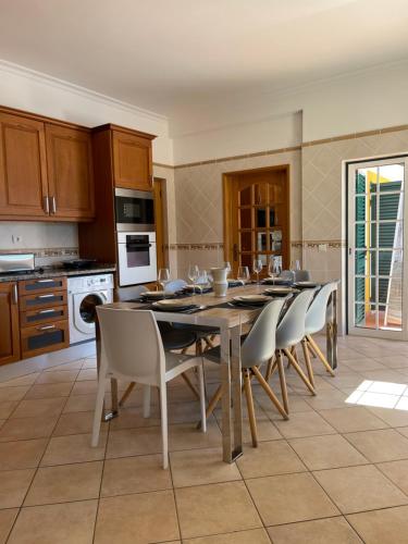 a kitchen with a dining room table and chairs at Oliva House in Lagos