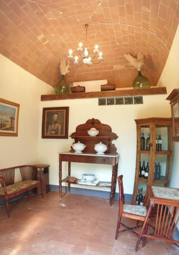 a room with a table and chairs and a chandelier at Villa Bruna in Poggibonsi