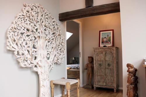 a white tree sculpture on a wall in a room at Loft Design Typikindi in Douai