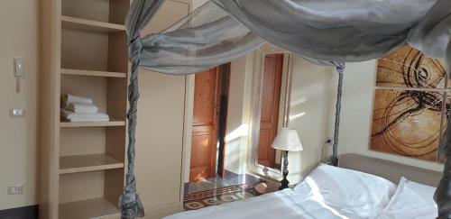 a bedroom with a bed with a canopy and a window at Villa Bruna in Poggibonsi