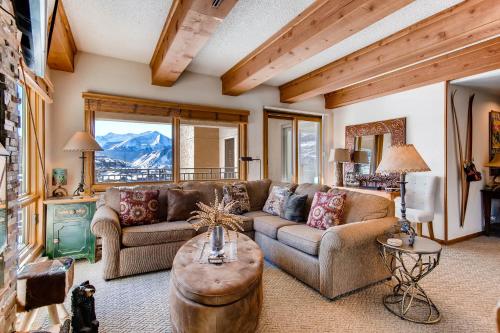 a living room with a couch and a table at 2 Br 2Ba Spacious Condo With A Fireplace Condo in Crested Butte