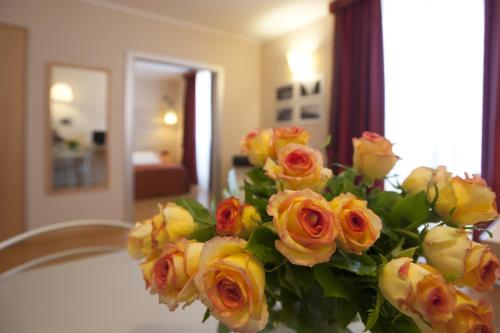 a bouquet of yellow roses sitting on a chair at AlbaResidence Masera26 in Alba