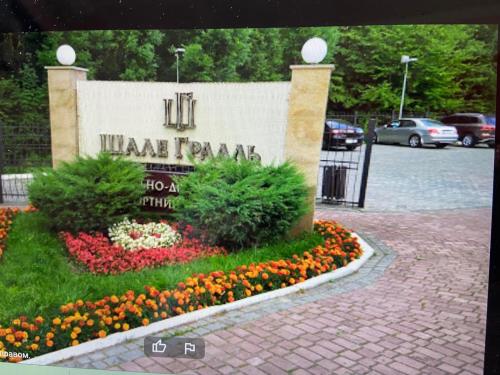 Una señal para un parque con flores delante. en Апартамент в отеле "Шале Грааль" г Трускавец, en Truskavets