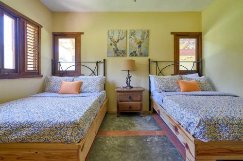 a bedroom with two beds and a night stand at Escape Chalet at Pinar del Sol in Jarabacoa in Jarabacoa