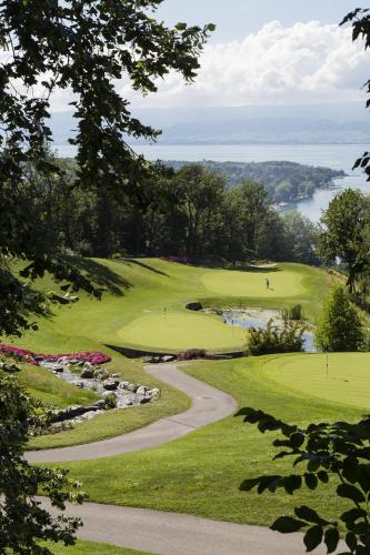 a view of a golf course with a winding green at Le Manoir du Golf in Publier