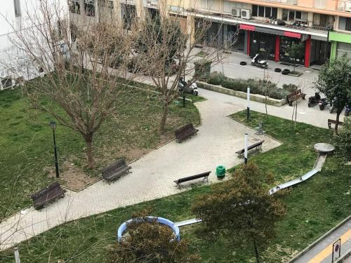 a park with benches and a playground in a city at Sweet Home Serres premium living in Serres