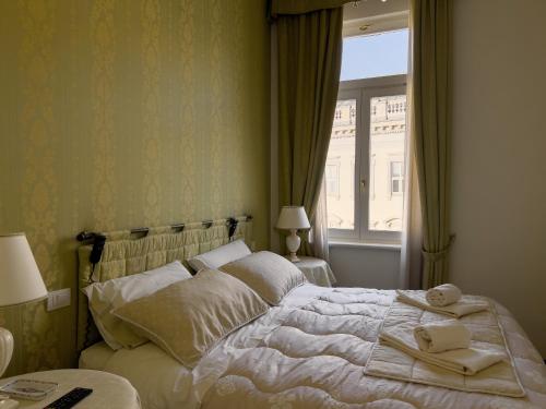 Ένα ή περισσότερα κρεβάτια σε δωμάτιο στο Trieste Luca's Home