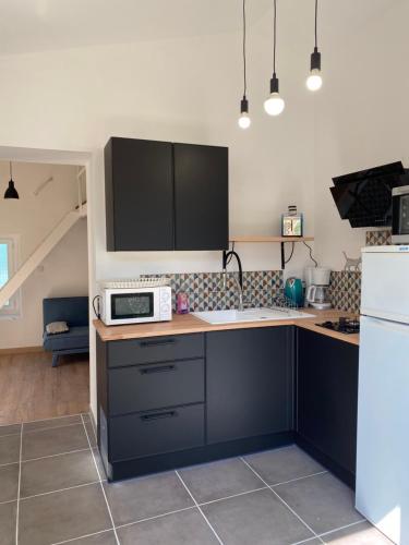 La cuisine est équipée d'un four micro-ondes et d'un réfrigérateur. dans l'établissement Gîte Lou Sabaï au pied des dentelles de Montmirail, piscine partagée, à Aubignan