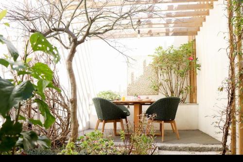 a patio with two chairs and a table at T'Luz in Porto