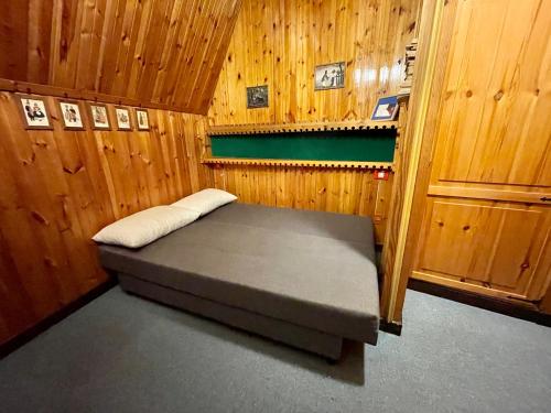 a small room with a bed in a wooden room at Appartamento Residence Excelsior Terminillo in Terminillo