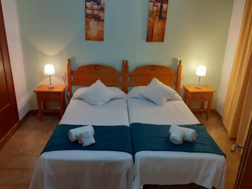 a bedroom with two beds with pillows on them at Portal 17 Can Tort in Tossa de Mar