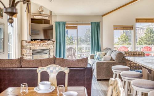 a living room with a couch and a table at Pelicans Watch - Meredith Lodging in Pacific City