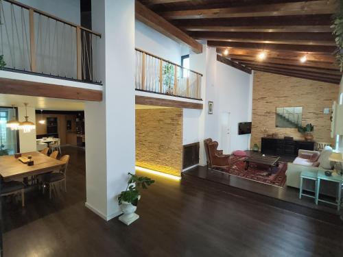 a living room with a table and a dining room at CASA RURAL ALEGRE in La Fresneda