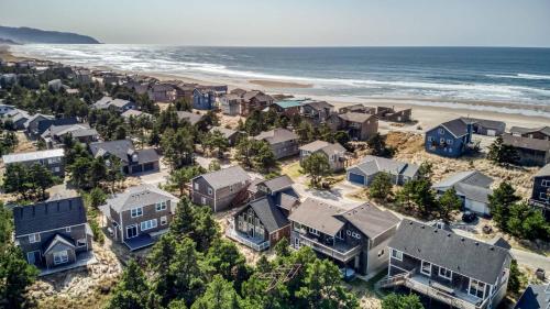 an aerial view of a beach with houses at Pelicans Watch - Meredith Lodging in Pacific City