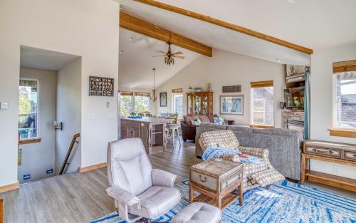 a living room with a couch and a table at Pelicans Watch - Meredith Lodging in Pacific City