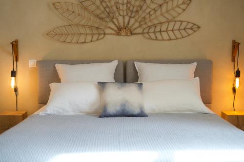 a bedroom with a bed with two pillows at Aux coeurs du Méjean in Mas Saint-Chély