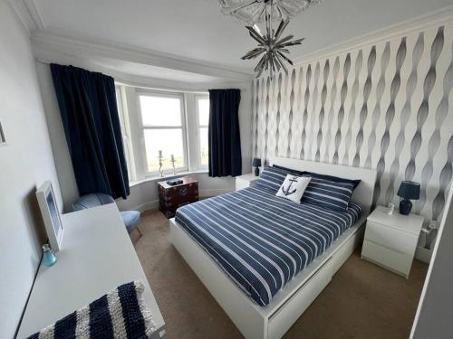 a bedroom with a bed and a desk and a window at Fantastic 3 bedroom holiday home in Millport