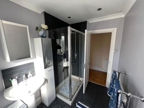 a bathroom with a shower and a sink at Fantastic 3 bedroom holiday home in Millport