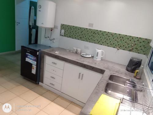 a kitchen with a sink and a counter top at Edificio Castelli 90 in Chumillo