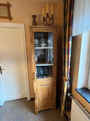 a wooden cabinet in a corner of a room at Ferienhaus Hanna in Emden