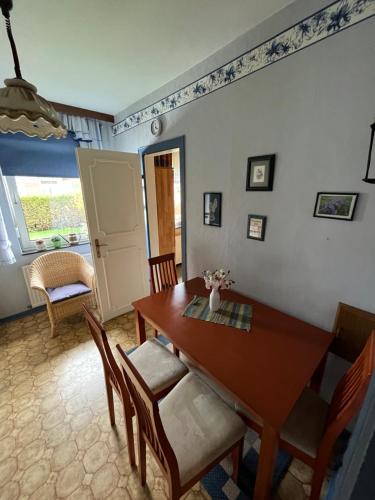 a dining room with a wooden table and chairs at Ferienhaus Hanna in Emden