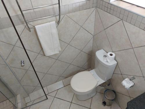 a bathroom with a toilet and two rolls of toilet paper at St Lucia Lodge in St Lucia