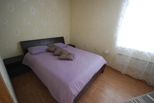 a bedroom with a bed with two shoes on it at City Apartment in Kuressaare