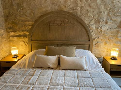 a bedroom with a large bed with two lamps on tables at La Magnanerie en Provence in Niozelles