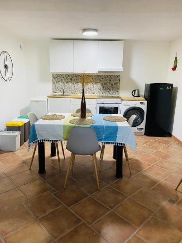 a kitchen with a table and chairs in a kitchen at Apulian Way in Torre Pelosa