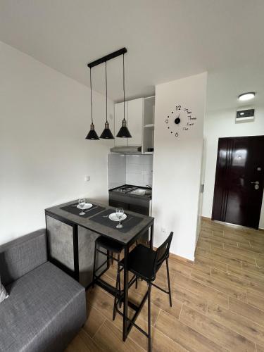a kitchen and dining room with a table and a couch at Apartment 55 Belgrade in Belgrade