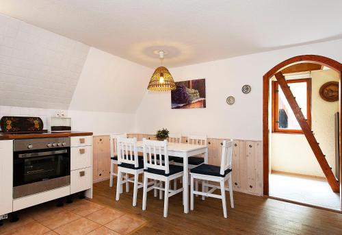 a kitchen with a table and chairs in a room at Ferienhaus Katharina in Malschwitz