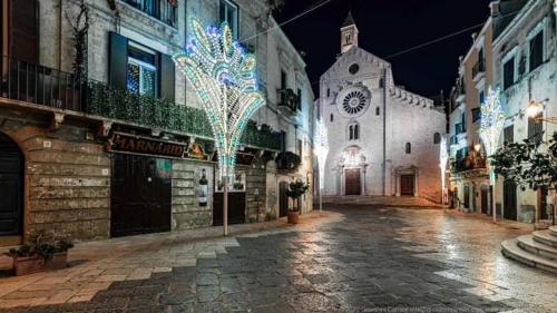 an empty street at night with a church with lights at B&B Romeo in Bari